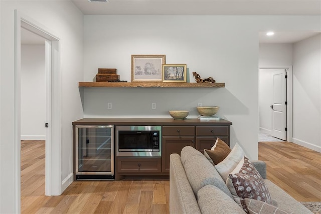 6509 NE 97th St, Oklahoma City, OK 73151 - indoor dry bar with beverage cooler, stainless steel microwave, light wood-style floors, and recessed lighting