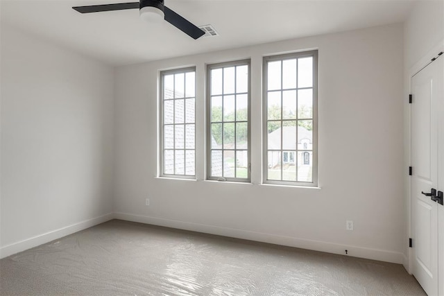 6509 NE 97th St, Oklahoma City, OK 73151 - spare room with healthy amount of natural light, a ceiling fan, and carpet flooring