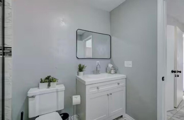 bathroom featuring vanity and toilet