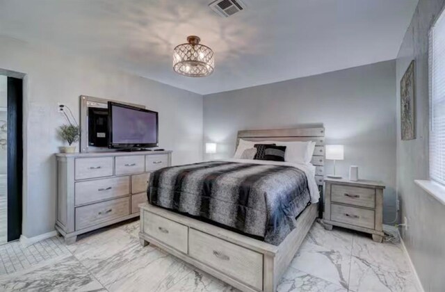 bedroom featuring an inviting chandelier, baseboards, marble finish floor, and visible vents