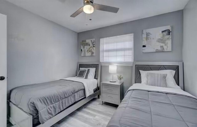 bedroom with a ceiling fan and wood finished floors