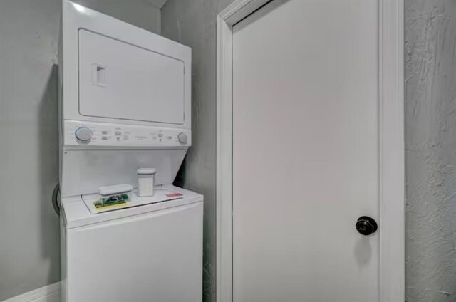 washroom featuring laundry area and stacked washer and dryer