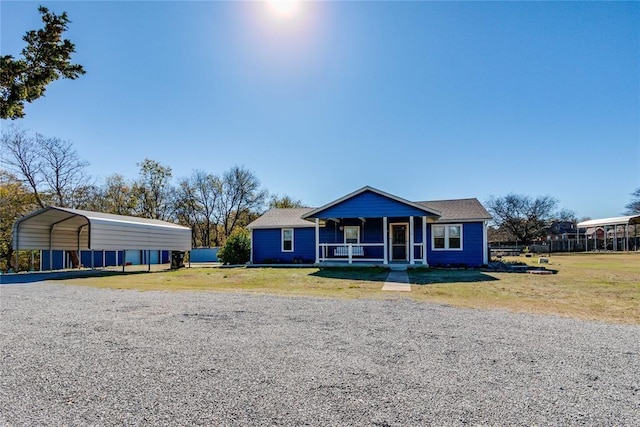 20318 State Highway 39, Purcell, OK 73080 - bungalow-style home with covered porch, a front yard, and a carport
