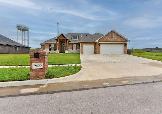 9600 Sultans Water Way, Yukon, OK 73099 - view of front of home with brick siding, an attached garage, driveway, a front lawn, and roof with shingles