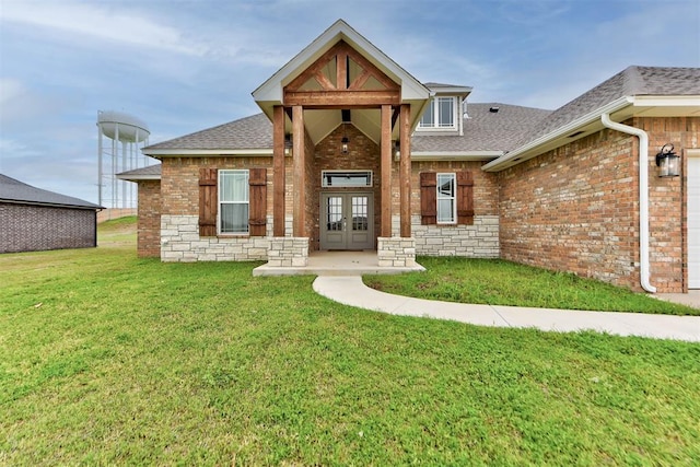9600 Sultans Water Way, Yukon, OK 73099 - view of front of house with french doors, brick siding, roof with shingles, a front lawn, and an attached garage