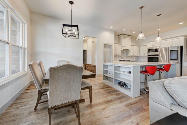9600 Sultans Water Way, Yukon, OK 73099 - dining space featuring a chandelier, light wood-style floors, recessed lighting, and baseboards