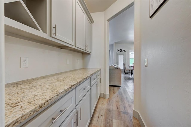 9600 Sultans Water Way, Yukon, OK 73099 - kitchen with light wood-style floors, baseboards, and light stone countertops