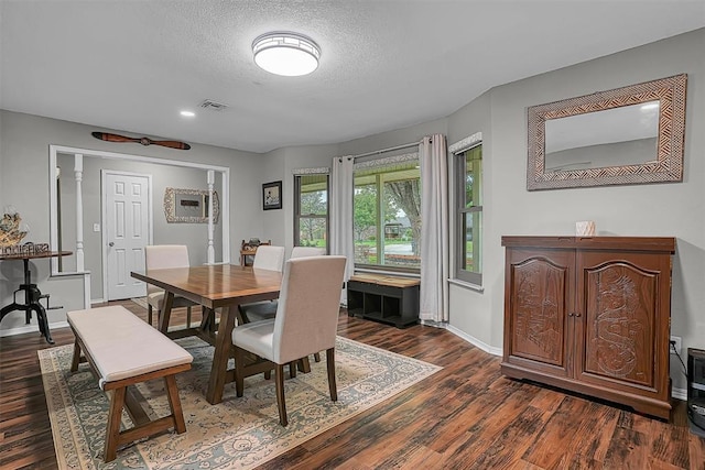 dining area featuring a textured ceiling, visible vents, baseboards, recessed lighting, and dark wood-type flooring