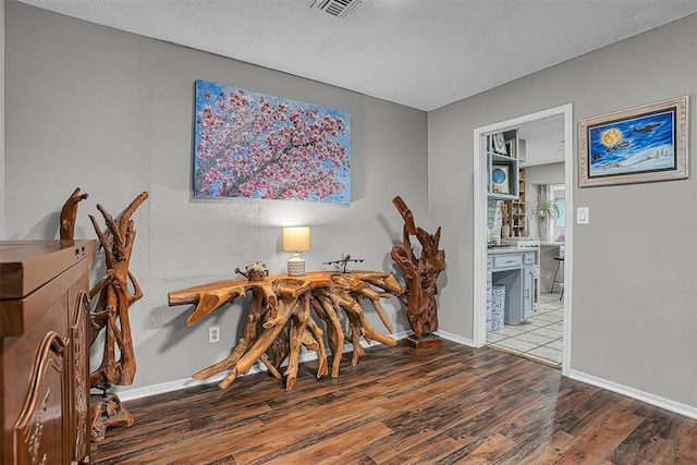 dining area featuring baseboards, wood finished floors, and visible vents