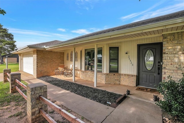 20428 E County Road 1567, Altus, OK 73521 - property entrance with covered porch, brick siding, and a garage