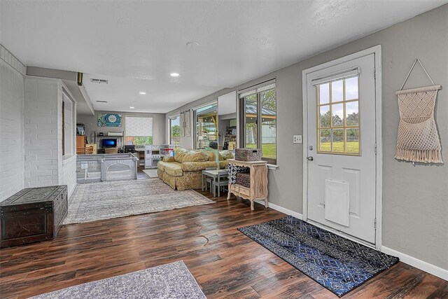 20428 E County Road 1567, Altus, OK 73521 - living area with wood finished floors, a glass covered fireplace, baseboards, and recessed lighting
