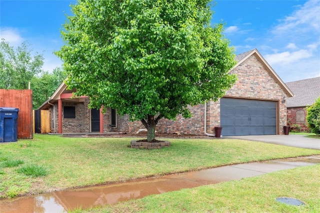 1904 Timber Xing, Yukon, OK 73099 - obstructed view of property featuring brick siding, an attached garage, driveway, and fence