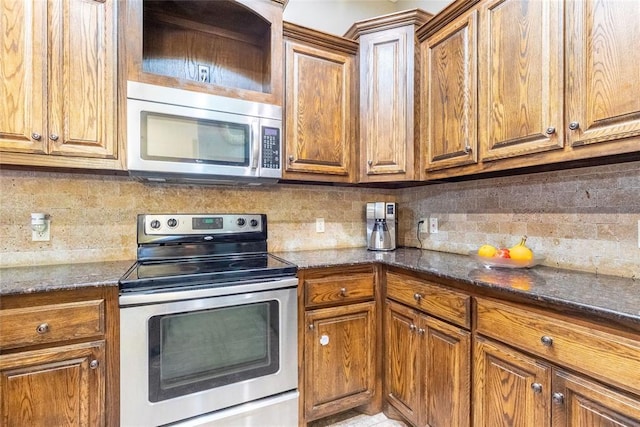 1904 Timber Xing, Yukon, OK 73099 - kitchen with appliances with stainless steel finishes, decorative backsplash, and brown cabinetry