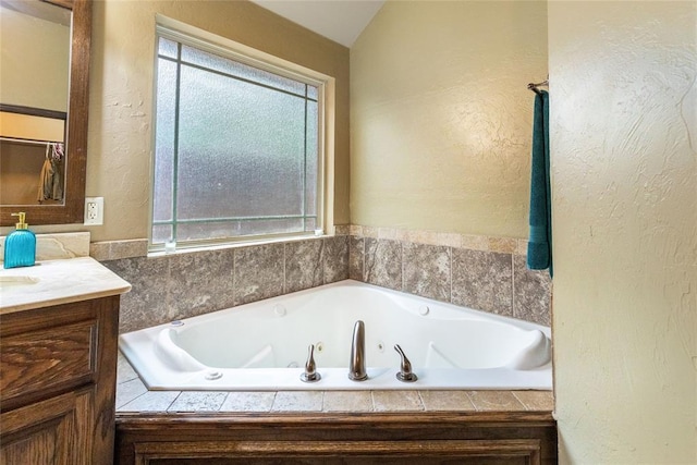 1904 Timber Xing, Yukon, OK 73099 - bathroom featuring a tub with jets, a textured wall, and vanity