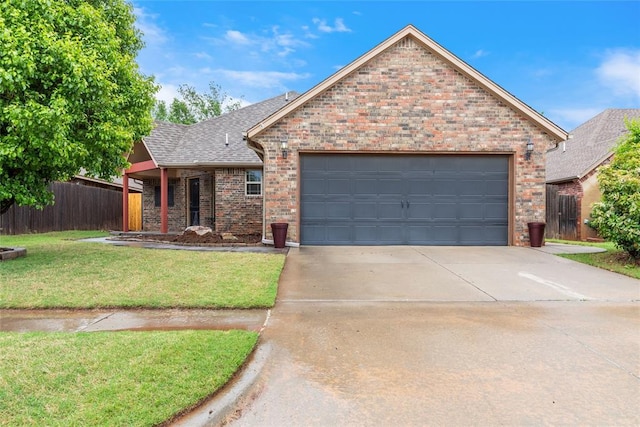 1904 Timber Xing, Yukon, OK 73099 - view of front of house with brick siding, an attached garage, fence, and a front yard