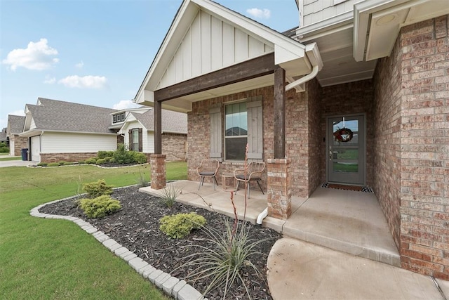 property entrance with a lawn, board and batten siding, a porch, and brick siding