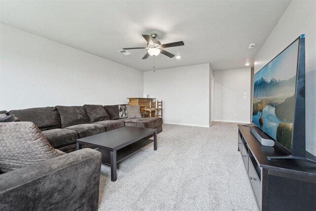 carpeted living area featuring a ceiling fan, baseboards, visible vents, and recessed lighting