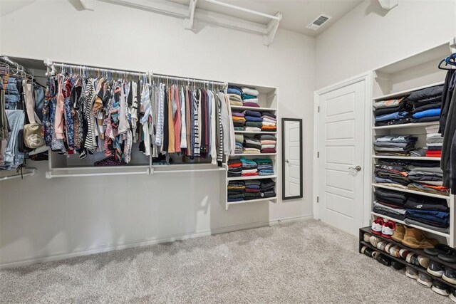 spacious closet featuring carpet flooring and visible vents