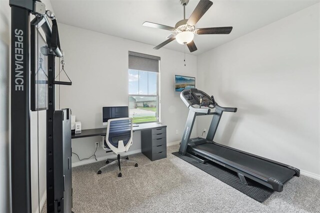 office space with carpet floors, ceiling fan, and baseboards