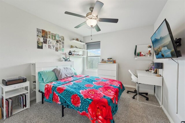 carpeted bedroom featuring ceiling fan and baseboards