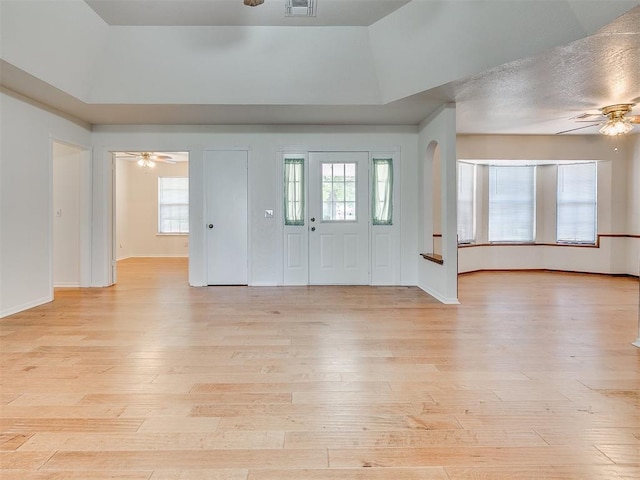 10601 Songbird Ln, Oklahoma City, OK 73130 - entryway with visible vents, light wood-style floors, baseboards, a raised ceiling, and a ceiling fan