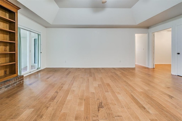 10601 Songbird Ln, Oklahoma City, OK 73130 - empty room featuring a raised ceiling, baseboards, and light wood-style flooring