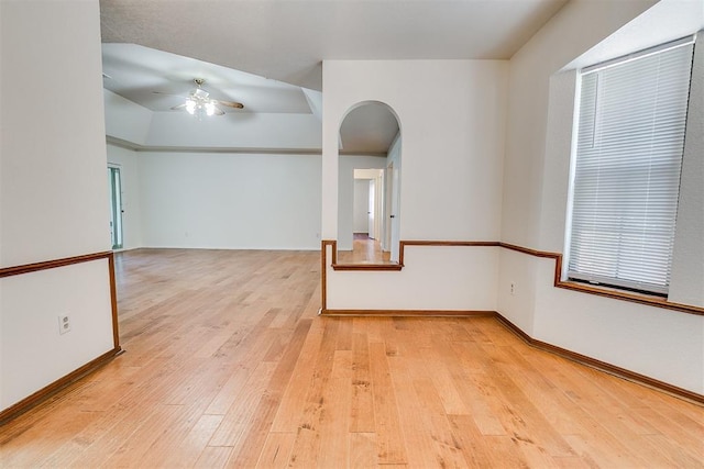 10601 Songbird Ln, Oklahoma City, OK 73130 - empty room with baseboards, a ceiling fan, light wood finished floors, and arched walkways