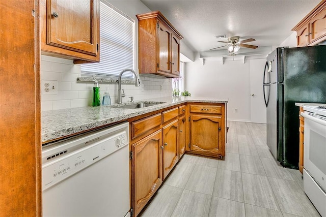 10601 Songbird Ln, Oklahoma City, OK 73130 - kitchen with brown cabinets, a sink, white appliances, a ceiling fan, and tasteful backsplash