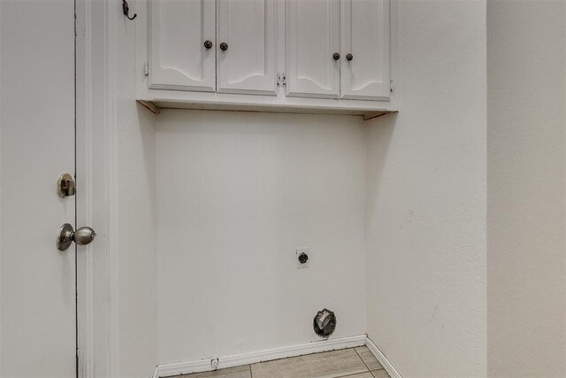 10601 Songbird Ln, Oklahoma City, OK 73130 - laundry area with cabinet space, hookup for an electric dryer, and baseboards