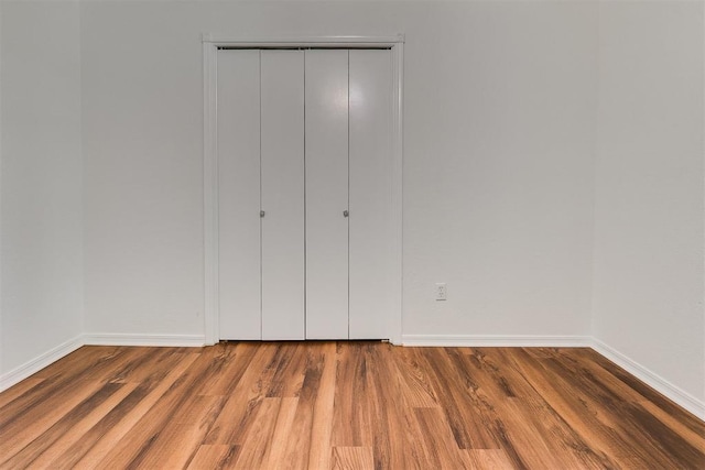 10601 Songbird Ln, Oklahoma City, OK 73130 - unfurnished bedroom with baseboards, a closet, and wood finished floors