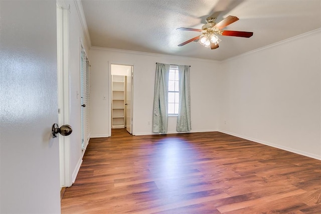 10601 Songbird Ln, Oklahoma City, OK 73130 - empty room featuring crown molding, baseboards, ceiling fan, and wood finished floors