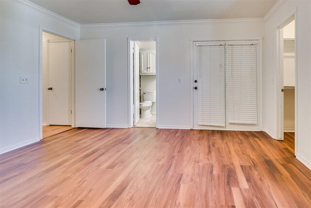 10601 Songbird Ln, Oklahoma City, OK 73130 - unfurnished bedroom with baseboards, ornamental molding, ensuite bath, and light wood-style flooring