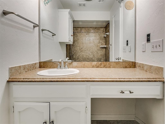 10601 Songbird Ln, Oklahoma City, OK 73130 - full bathroom with vanity, a tile shower, and visible vents