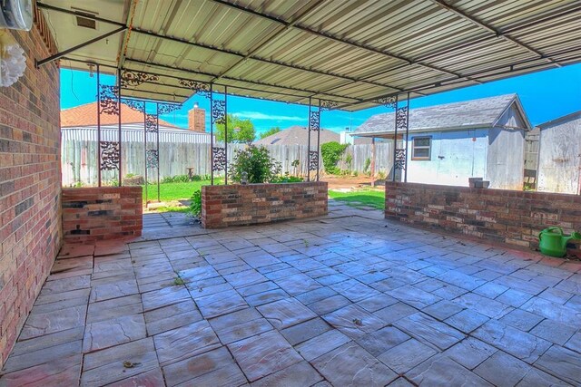 10601 Songbird Ln, Oklahoma City, OK 73130 - view of patio featuring a fenced backyard, an outbuilding, and a storage shed