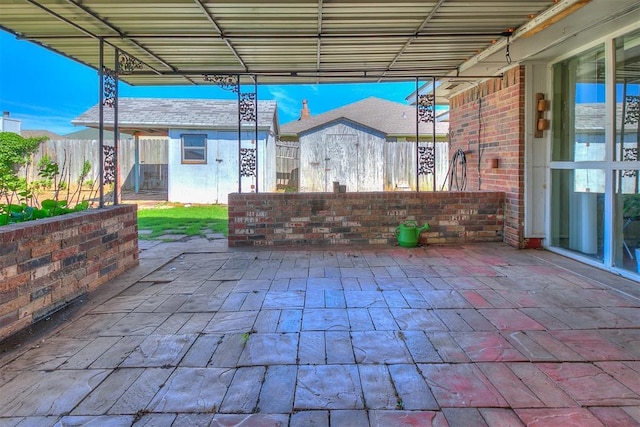 10601 Songbird Ln, Oklahoma City, OK 73130 - view of patio / terrace featuring a fenced backyard, a shed, and an outbuilding