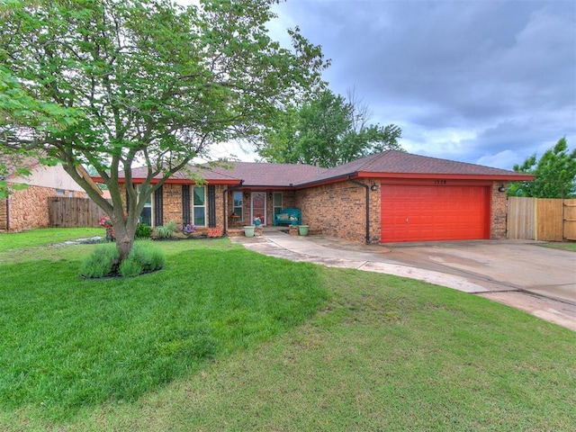 ranch-style house featuring a garage, brick siding, fence, a front lawn, and concrete driveway