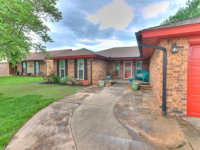 single story home with roof with shingles, brick siding, and a front yard