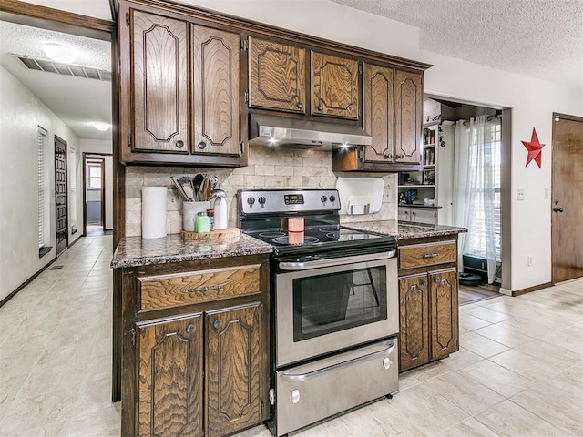 kitchen with electric range, a textured ceiling, light tile patterned floors, tasteful backsplash, and under cabinet range hood