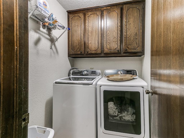 clothes washing area with cabinet space and independent washer and dryer