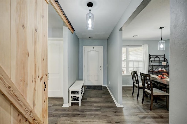 entrance foyer with baseboards and wood finished floors
