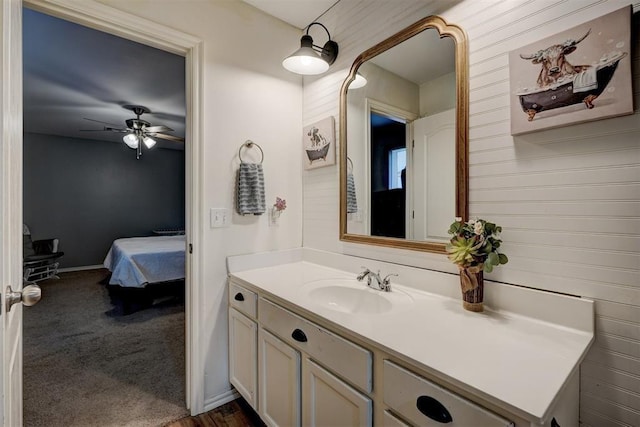 ensuite bathroom with vanity, a ceiling fan, baseboards, and ensuite bath