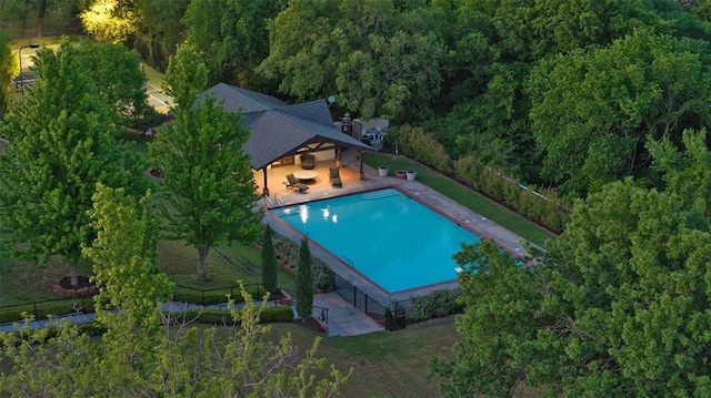 2203 E Wilshire Blvd, Oklahoma City, OK 73111 - view of swimming pool with a patio, fence, and a view of trees