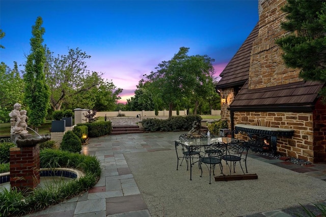 2203 E Wilshire Blvd, Oklahoma City, OK 73111 - view of patio featuring an outdoor stone fireplace and fence