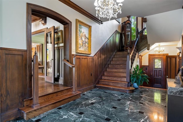 2203 E Wilshire Blvd, Oklahoma City, OK 73111 - stairs featuring a chandelier, wainscoting, marble tiled floors, plenty of natural light, and ornamental molding