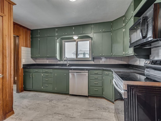 kitchen with a sink, marble finish floor, appliances with stainless steel finishes, and green cabinets