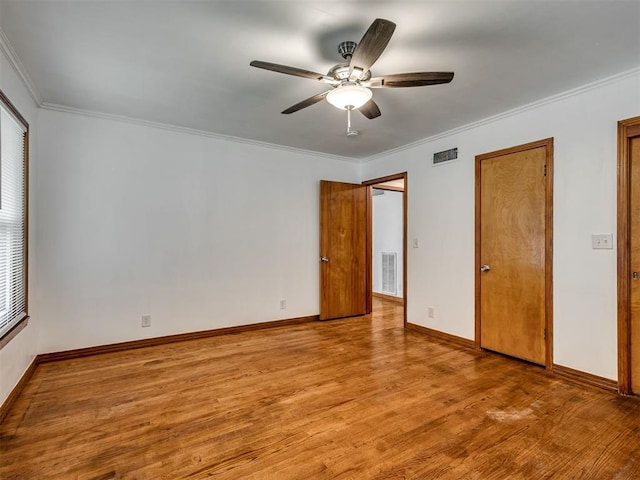 unfurnished bedroom featuring crown molding, visible vents, and light wood finished floors