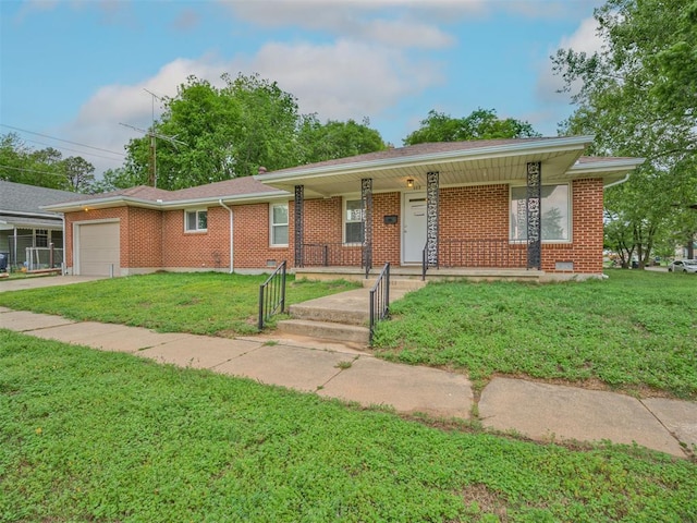 single story home featuring a front lawn, brick siding, a garage, covered porch, and driveway