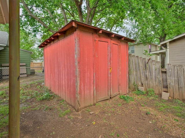 view of shed featuring fence