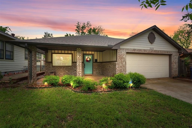 ranch-style home with a garage, a front lawn, covered porch, brick siding, and concrete driveway