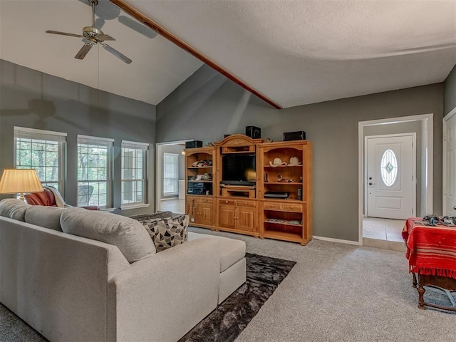 carpeted living room featuring baseboards, ceiling fan, a wealth of natural light, and high vaulted ceiling